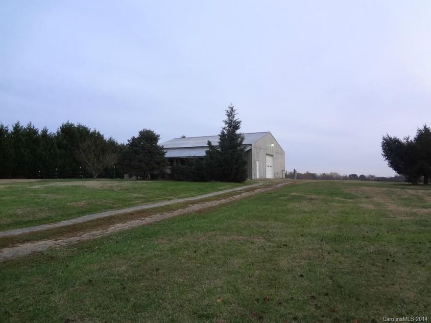 Unique property -- huge shop with 2 BR apartment to live in while you build your dream home in this lovely location right at the Iredell/Rowan County line just outside Mooresville.  5.6 acres of property with fenced pasture already in place for your horses, foundation started for a custom home, 4 bedroom septic & well in place, & a massive shop for the auto enthusiast.  Beautiful setting surrounded by custom homes and just off Mazeppa Road area of Mooresville.