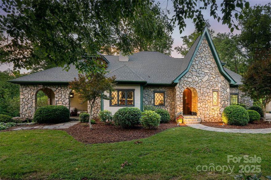 GROVE PARK HOME + GUEST COTTAGE ON IDYLLIC ESTATE GROUNDS W/CREEK! Stately Tudor-style home, inspired by the owners' admiration for the nearby Grove Park Inn, showcases stunning details inside and out. Main home features a spacious + elegant floor plan, highlighted by beautiful design elements that evoke the feeling of a historic home. Vaulted wood-beamed ceilings, stained glass insets + open staircase leading to the second level. Primary bedroom suite is conveniently located on main level and includes a comfortable sitting area, private bath + spacious walk-in closets. Upstairs, you'll find 3 guest bedrooms + guest bath + abundant walk-in attics for storage. Quaint guest cottage offers the perfect private space for hosting, w/separate entrance, parking, kitchen + living area. A rare find in Grove Park, the grounds are incredibly private + bordered by a tranquil creek. Enjoy the picturesque surroundings from the covered stone patio or the sunny deck. Walk to the GPI. . .minutes to DT.