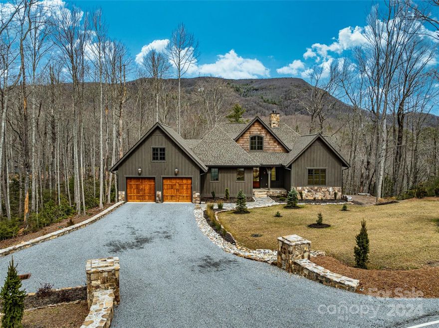 If you've considered building a new home but don’t want to go through the time and unknowns of a new build - look no further!  This home was completed in late 2022 and has been very gently used. Beautiful high end finishes with large open spaces.  Each bedroom is en-suite and provides privacy for family members and guests.  Level entry with beautiful view of Hogback mountain.  Enjoy coffee as you wake up to the sunrise out your back windows and relax with a glass of wine in the evening under your covered, screened in deck.  Bathed in natural light and completely move in ready.  Full home generator and fiber optic cable invites you to live and work here year round.  Burlingame is close to everything.  Surrounded by lush forests, hiking trails and waterfall galore.  Located about 60 minutes from the Asheville airport, 15 minutes to the vibrant town of Cashiers and 30 minutes to main street Highlands.  Gourmet restaurants, shops, entertainment, hiking, fishing and so much more await you!