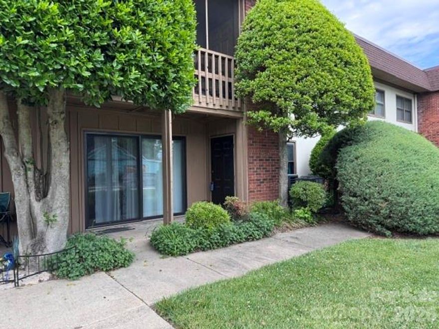 All the "heavy lifting" work has been completed on this ground-level, two-bedroom condominium near Pardee Hospital and Medical Center in downtown Hendersonville. The unit's HVAC was replaced in 2021. A radon mitigation system has been installed. The well-equipped kitchen has been updated with new appliances, including a microwave, oven/range and dishwasher, and a full-size refrigerator with ice maker. In addition, you'll love the farm-style sink, quartz countertops, and new cabinets and lighting. Enjoy the large living and dining area, with easy-care engineered hardwood floors throughout. The hallway full bath features a vintage vanity and tub with shower. Both spacious bedrooms have been freshly painted. The primary bedroom offers a walk-in closet and a half-bath with (surprise!) its own washer, while the second bedroom has a double closet for additional storage space. Upgraded windows and a newer 8 ft. sliding door provide insulation and soundproofing from downtown traffic. Outside, enjoy the patio and even do a little gardening, if you wish. For residents, the building provides a fully equipped laundry room and a locked storage area with assigned closets. HOA fees include water, sewer and trash service. Rentals and pets are allowed; conditions apply. An electric fireplace in the living room, a wall-mounted TV and a dining set convey with purchase. This residence offers an easy lifestyle convenient to downtown shopping, business and healthcare resources, and is just a few blocks from Hendersonville High School and Middle School.