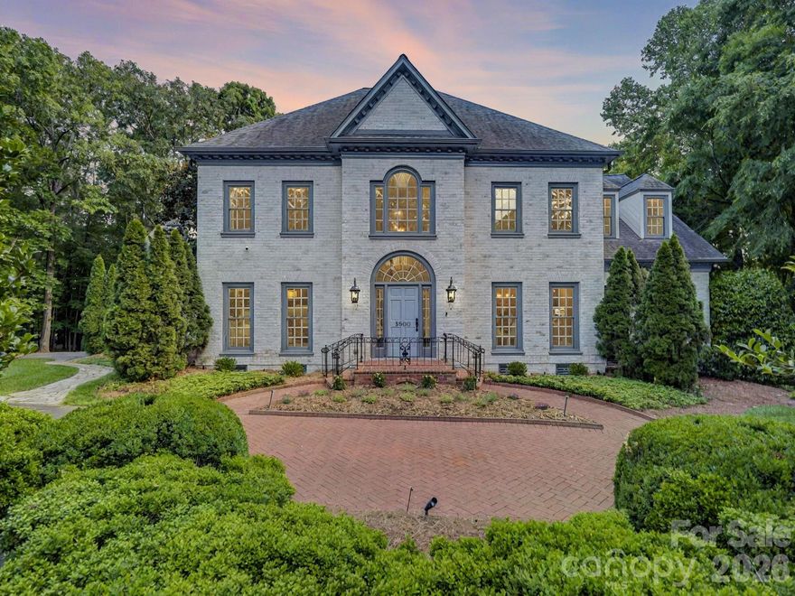 5500 Hardison Road is stately, stylish, and the definition of estate living. Tucked in the back of established Pellyn Wood, this executive home pairs gorgeous curb appeal with the privacy of a 1.38-acre lot, a rare offering so close to SouthPark. Inside, a two-story foyer with a beautiful curved staircase sets the tone. The main level features a spacious formal dining room, sitting room/study, and cozy family room with fireplace, built-ins, and wet bar. The kitchen offers painted cabinetry, quartz countertops, and high-end appliances, including double Thermador ovens and warming drawer. Natural light fills the space and extends into the breakfast room, where a bay window frames wooded views. The main-level primary suite features a tray ceiling, two closets, and a spacious bath, again with incredible views of the resort-style backyard. Upstairs, you’ll find four additional bedrooms, including two en-suites, plus a playroom/flex space and a dedicated home office with fireplace. The bedroom/bonus room features a wall of built-ins with refrigerator drawers. Permanent stairs lead to 562 square feet of attic space with French doors and a terrace, offering excellent expansion potential. Relax on the covered back porch with grilling station, overlooking the pool with hot tub, waterfall, paver patio, and outdoor fireplace. Here, you can forget you’re in the city as you take in the surrounding nature. Upgrades throughout, including refinished hardwoods on the main level, new white oak hardwood flooring upstairs (no carpet), a fully sealed crawlspace, and a garage with epoxy flooring and customized built-in storage. This address offers value, presence, and a feeling that is hard to replicate in newer neighborhoods. Welcome home! Showings begin Thursday by appointment only.