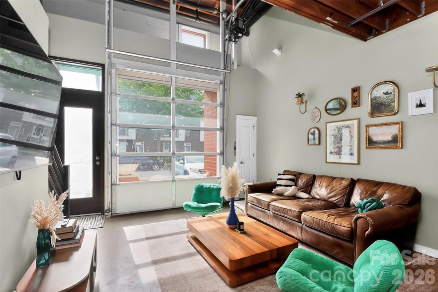 Unique loft-style condo located in the heart of NoDa’s arts district, just a short distance to restaurants, breweries, and the light rail. Situated in a historic mill conversion, this 2-story industrial condo features exposed beams, concrete and hardwood floors, and an open, airy layout filled with character. The standout feature is the oversized garage-style door that opens to extend the living space —perfect for enjoying during ideal weather. Don't miss the screen as an option for when you do not want complete open air. . Community amenities include a shared firepit and grill area for relaxing or entertaining. New HVAC in 2021 adds peace of mind. A rare opportunity to own a true industrial-style space in one of Charlotte’s most vibrant neighborhoods.
