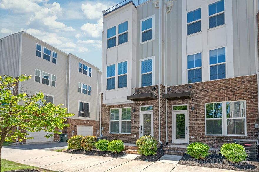 Bright and spacious 4-story END UNIT townhome centrally located in Optimist Park. Built in 2020 and move-in ready with fresh paint. This lovely home features a roof top terrace + open floor plan perfect for entertaining. Modern kitchen has timeless touches, white shaker cabinets, quartz countertops, and gas range. Primary suite features double vanity and walk-in closet. All 3 bedrooms feature full ensuite baths. The 4th floor guest suite can accommodate a king, and the loft space is a great secondary living area - providing privacy and separation for overnight guests. Attached 2-car garage + Nest thermostats. Grab a bite from Optimist Hall, or enjoy the greenway after your work calls (the entrance is one block away at 16th & Davidson). The Parkwood light rail station is 2 blocks away and provides quick access to uptown, NoDa, and SouthEnd. HOA maintains all landscaping - making this a true "lock and leave" for those who enjoy traveling or weekends away. All appliances will remain!