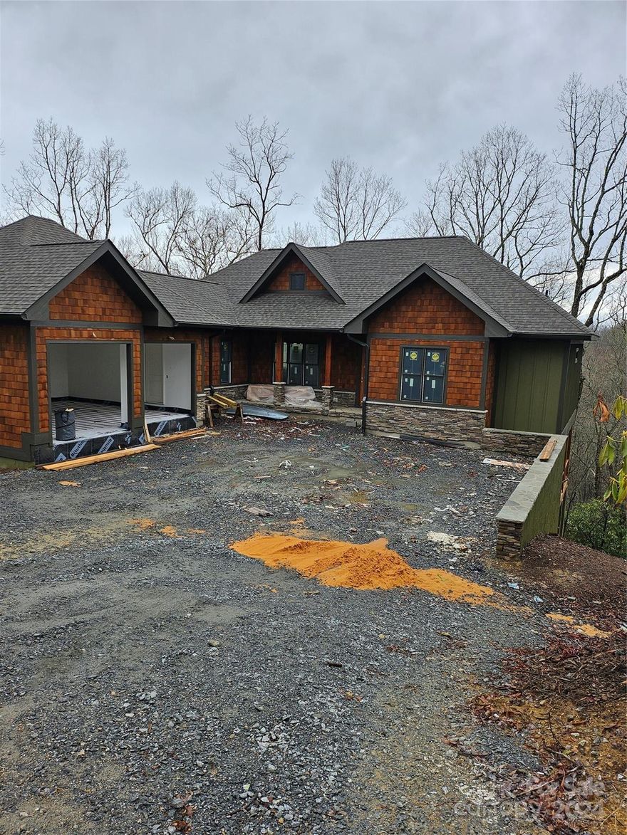 Masterfully crafted 4BR/4.0BA  Crone Custom Home featured in Connestee Falls, a Premier Western NC Gated Community. Includes sweeping western mountain views, four mountain lakes, miles of hiking trails, golf, clubhouse, restaurants, new fitness center to be completed in April 2024, heated pool, pickleball, tennis, and walking track. The home features a spacious open floor plan, a great room with a massive stone fireplace, a high pine-clad vaulted ceiling, and a gourmet kitchen with custom cabinets, granite, and S/S appliances—two master suites on the main level. wood floors/granite tops throughout, Open/Covered partially screened upper and lower rear decks. Lower lever with two ensuites, family room with wet bar includes a beverage frig. Separate storage with outside side deck. Come see why we love living where we play. Home to be completed shortly.