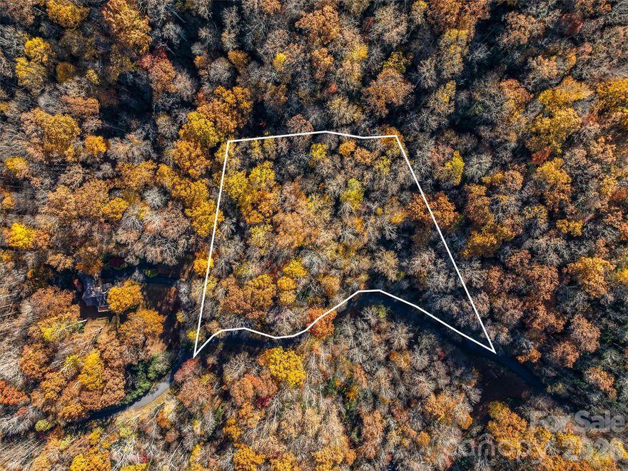 Discover the beauty of mountain living in the desirable Glen Cannon community in Pisgah Forest. This 1.88-acre wooded homesite offers privacy, character, and natural charm, highlighted by striking rock outcroppings and glimpses of foxfire. The property is richly covered with hardwoods and rhododendron thickets, creating a peaceful, natural setting. A walking path leads to the upper ridge line where a potential homesite awaits, offering the opportunity for beautiful long-range mountain views once selectively cleared. Walking sticks are even provided at the trail entrance to make exploring the property easier—just bring your hiking shoes and imagination. This could be the perfect spot for your dream mountain home in a friendly, well-established neighborhood, just minutes from Pisgah National Forest, Dupont State Forest, and the charming town of Brevard. A 3-bedroom septic permit is already on file.