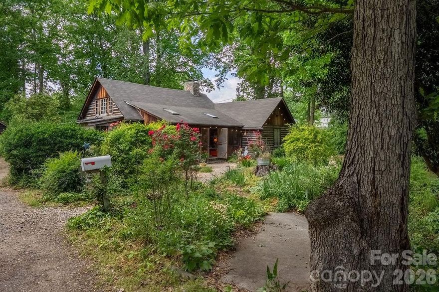 Welcome to a rare and special property in the highly desirable Oakhurst/Amity Gardens neighborhood. Located just 4 miles from Uptown Charlotte, with easy access to public transport, shopping, restaurants and schools, "The Poets Cabin" is nestled on over an acre of very private, natural property. Hand-built with gorgeous solid woods in the early 1930s, here everyday living feels like a peaceful mountain retreat in the heart of Charlotte - a perfect place emphasizing quality of life without sacrificing convenience.

This home offers timeless charm and character at every turn. Come down the natural walkway surrounded by magnificent plants, flowers and trees. Enter the large, screened front porch perfect for outdoor dining and entertaining. Step through the vintage Dutch door adorned with custom ironwork and you’re immediately greeted by soaring ceilings and exposed wooden beams in the family and dining areas creating a light, airy feel. Historic details are thoughtfully preserved throughout, including crank-operated windows, white oak floors and original wall sconces. The large stone fireplace anchors the main living space, complete with decorative iron convection vents and a hearth crane designed for large pots for open fire cooking, an extraordinary nod to the home’s history. A small greenhouse is tucked away off the back of the home for plant enthusiasts.

The generous gardens and stunning woods filled with countless song-birds offer their own unique outdoor living spaces. They invite to plant, take walks, play games, watch nature, listen, rest and meditate. There is a designated fire-pit area and a private well in original well-house that is used mostly for watering. Privacy is further protected by a 15 foot natural area easement on adjacent property. Natural area is noted on survey.

“The Poets Cabin” also boasts a creative pedigree as the Charlotte Repertory Theatre, Charlotte Folk Society, Moving Poets and many others used this home and property for artistic endeavors. For decades, it has been a place for readings, performances, dances, and concerts deeply woven into the Charlotte’s arts and creative community - a place of soul and gatherings. Every room, nook and corner presents an opportunity for livable space encouraging connection.

A separate cabin currently used as an artist studio sits on the property, featuring two large rooms, a fully plumbed bathroom, and an additional space that could easily be converted into a kitchen. Heating and air conditioning in the studio are currently only serviced by a portable HVAC and a dehumidifier, but an additional mini-split system is already purchased and can be installed. This approx 1000 sqft cabin offers excellent potential as a guest house or short-term rental opportunity.

The property also offers significant development potential. It s currently zoned N1-D, which could allow sub-division and the development of single family, duet, trio and quadruplex homes on a minimum lot size of 3500sf in accordance with the relevant regulations.

Due to the complexity of the age of this vintage home, this one of a kind property is being sold “As is." Showings preferred on Saturdays between 12-5 due to work-at-home schedules, but we will do our best to accommodate requests when given 24 hours notice.

Come experience “The Poets Cabin” for yourself, an extraordinary opportunity with a truly storied past and an enduring sense of place. This home is ideal for the discerning buyer who values serenity, natural beauty and the ability to entertain with ease in a central location.