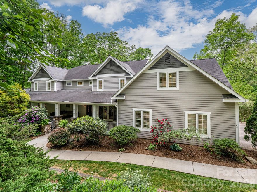 Discover refined mountain living at 307 South Braeside Ct. This exquisite estate is tucked away on a private 1.6-acre wooded sanctuary, offering a rare blend of secluded tranquility and immediate access to the vibrant lifestyle of Biltmore Park. Soaring ceilings and expansive glass invite abundant natural light, accentuating the warm mountain craftsmanship. Experience the rare flexibility of two identical primary suites. Choose the main-level sanctuary, or the private upstairs escape. Chef's kitchen offers "acres" of quartz counter space and abundant custom storage. Sub-Zero fridge/freezer duo, Dacor gas cooktop, and a walk-in pantry. Oversized elevator serves 3 floors. Walk-out basement- for easy storage, and future expansion. Enjoy morning coffee on the expansive covered front porch and quiet evenings on the screened-in back porch. The gracious open floor plan is perfectly tailored for both entertaining and active family living. Freshly painted inside and out, this home is truly move-in ready. Prime location offers easy access to schools, community pool, & upscale offerings nearby at Biltmore Park Town Square.