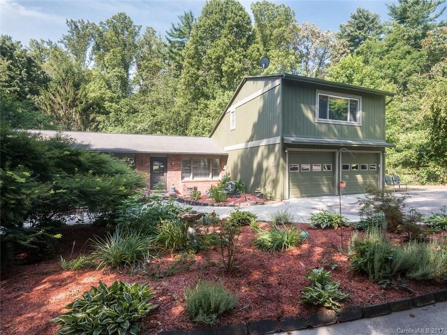 Spacious home privately located in the desirable Royal Pines area & TC Roberson school district, minutes from all south Asheville has to offer. Lovingly updated to include a finished loft suite above the 2 car garage,& kitchen w/ modern appliances. Home has attached 900sf guest suite, which can house extended family or provide rental income.The property boasts numerous perennial gardens that offer gorgeous color & scents throughout warm months. Large deck to view private fenced back yard w/ shed