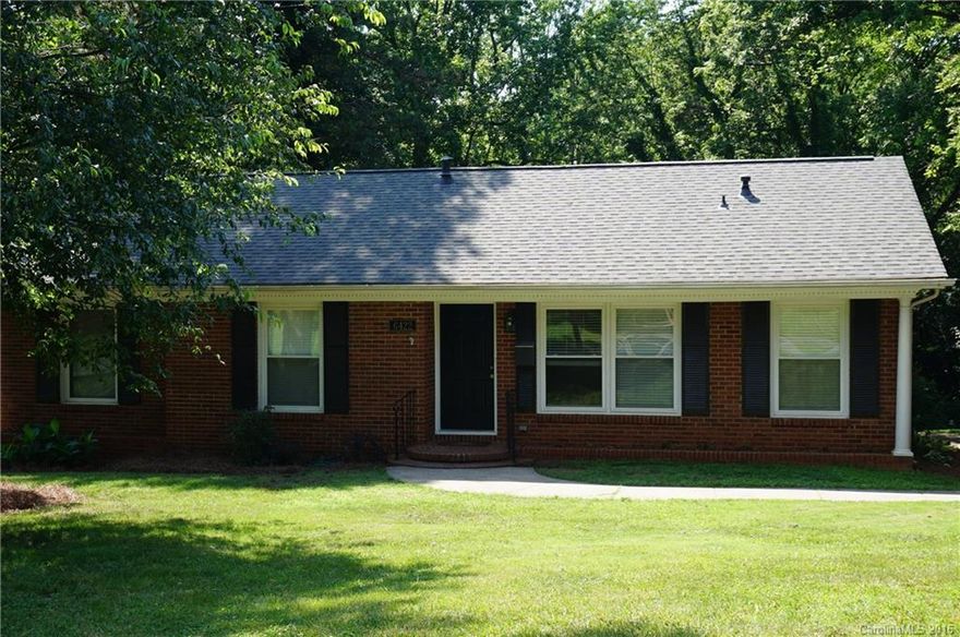 Nicely updated full brick home in desireable Starmount!  Move-in ready!! New cabinets and updated appliances in the kitchen.  Upgraded lighting, doors and windows.  Beautiful hardwood floors throughout, updated baths with tile floors and shower surround. Cozy sunroom with new flooring!  Oversized deck overlooks private wooded backyard.  Great location -- convenient to light rail, I-77 and South Park Mall.