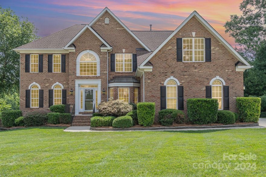 Stunning LAKEFRONT home with waterfall pool, hot tub, gazebo, dock and deck, & easy access to I-485! Relax or entertain with gorgeous center lake views from the entire home! Stylish home office on the main level with glass French doors. Dual stairways, spacious updated Primary Suite, Jack and Jill bath plus hall bath, and a large bonus w/ closet could be a 5th bedroom or additional living area. 3 car garage w/ epoxy floors and insulated doors. 2 new HVAC systems installed 2024 w/ warranties, tankless water heater. Picture the fun around the pool, hanging on the dock, entertaining in the open kitchen/great room areas! New pool filter in 2022, new pool heater in 2023, new Polymeric sand in pool pavers 2023! Pool equipment will convey. Irrigation system with grandfathered lake water usage. Timer controlled outside accent lighting. All with the community tennis courts, pool, clubhouse, fitness center, playground-and The Divide Golf Club in the neighborhood with state-of-the-art facilities!