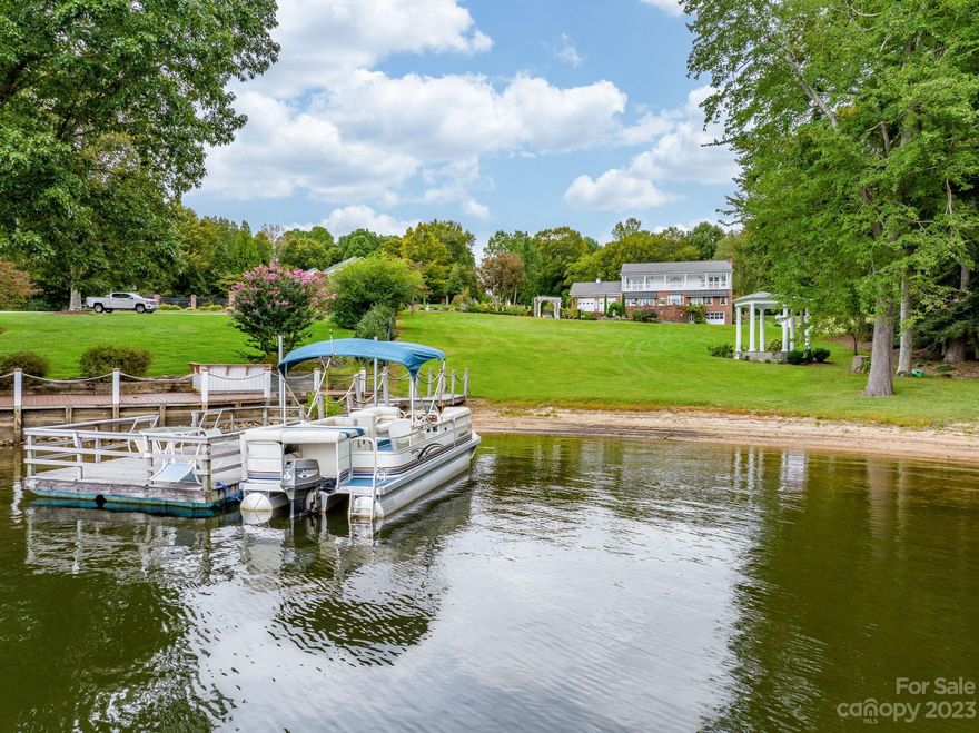 This isn't just any home; it's a one-owner custom-built masterpiece. Private double, over an acre lot allows you Lake Views you'll only dream about. Every detail, every corner, & every feature of this home reflects a lifetime of care & attention. The main level boasts a welcoming foyer, A cozy living room w/ FP that is open to the formal dining room. An oversized master suite w/hardwoods, walk-in closet, master bath w/ tile shower & soaking tub & FP.  Off master bath is a sunroom pass though from double garage to kitchen.  Kitchen has granite counter tops, SS appliances & eat in area with breathtaking views of the lake. The laundry room w/ sink & back patio complete the features on main.  Upstairs you'll find two oversized BR's, each w/ en-suite, full private BA's. Both BR's open to a balcony overlooking the lake one has FP. The unfinished basement offers shower/toilet & single car garage door, making it perfect for storage/workshop. Circle drive, Dock, Gazebo, Easy Walk to the Lake.