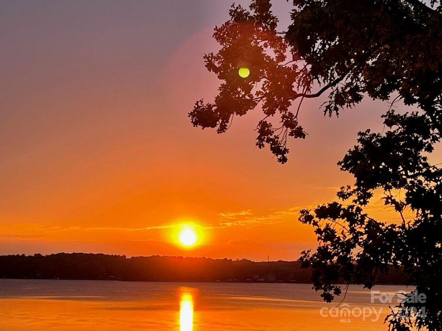 Awesome, very hard to find 1.45 acre WATERFRONT property with 174 sf of waterfront, sandy beach and amazing long-range views! Great location at the end of Brawley School Rd, past The Point Golf Course-Highly sought after! GORGEOUS SUNSET VIEWS!!! No HOA dues- No restrictions- low Iredell County taxes- partially wooded- 4 bed septic permit (3 bed installed)- Sandy beach. PLUS- Charming updated house w/updated kitchen, quartz countertops, gas stove, hardwood floors, great room w/stone fireplace, updated bathrooms, large bonus room w/breathtaking views you'll never get tired of! It doesn't stop there..also enjoy the convenience of the adorable detached "She-Shed" w/kitchenette, living room, fireplace, upstairs loft and bath. Feel like you are on vacation EVERYDAY!!!