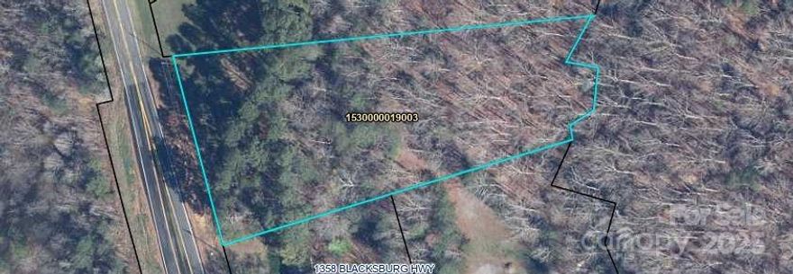 Mostly wooded lot has approximately 1.75 acres. 
Has approximately 214 ft frontage on Blacksburg Hwy about 1/3 mile +/- N of I 85 at Exit 102.
Appraisal considers highest and best use to be low density residential, but there are no restriction.
Has public water available.  Purchaser will need septic.
No public zoning but seller reserves right to approve anticipated use to protect brick house for sale nearby.
