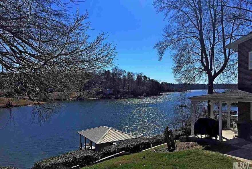 Ready to Play on the Lake? Take a look at this well maintained home with beautiful Lake Hickory views and 276 waterfront feet on 3 lots! This home was made for entertaining on the lake and includes a 24' Pontoon and 9' Seadoo! Two bedrooms up and one down with office and nice laundry room off the kitchen. Enjoy the lake breezes on one of the rocking chairs on the back patio or from the picnic bench on the deck or from the porch swing on covered dock or even from the sunroom! Great room offers gas log fireplace and dining area with built-ins. Sunroom with Chatahoochee flooring and windows all around.  Covered Dock with Boat Lift and Closet full of lake toys. Shed included with fridge, AC/Heater & shelves for workshop. Circle drive with porte cochère. Lots of parking space.