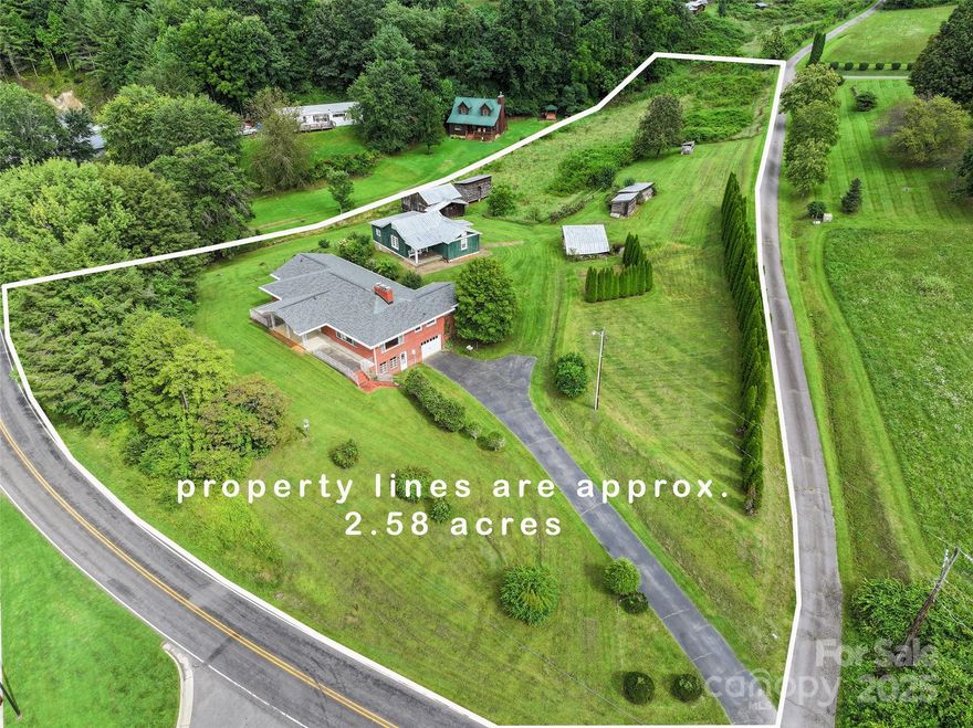 Exceptional 2.58-acre property with 350+ feet of road frontage, offering prime visibility and long-range views. This pristine, level-to-rolling pasture is "not zoned" allowing residential, commercial, or multipurpose use accepted and is located just 100 yards from the bustling highest traffic count Russ Ave and Dellwood Rd 5-lane intersection, behind Dunkin’ Donuts and Dollar General. The 2,200+ sqft brick ranch features a 10x20 covered front porch, 3 bedrooms, 3 baths, abundant natural light, a large formal living and dining room, and hardwood floors. An 1,800+ sqft unfinished basement offers endless potential. Adding historic charm, a 103-year-old cabin and barn await restoration. Connected to public water/sewer, this property is ideal for a private estate, commercial development, or mixed-use project. Don’t miss this rare opportunity to own a unique blend of modern convenience, historic character, and prime location!