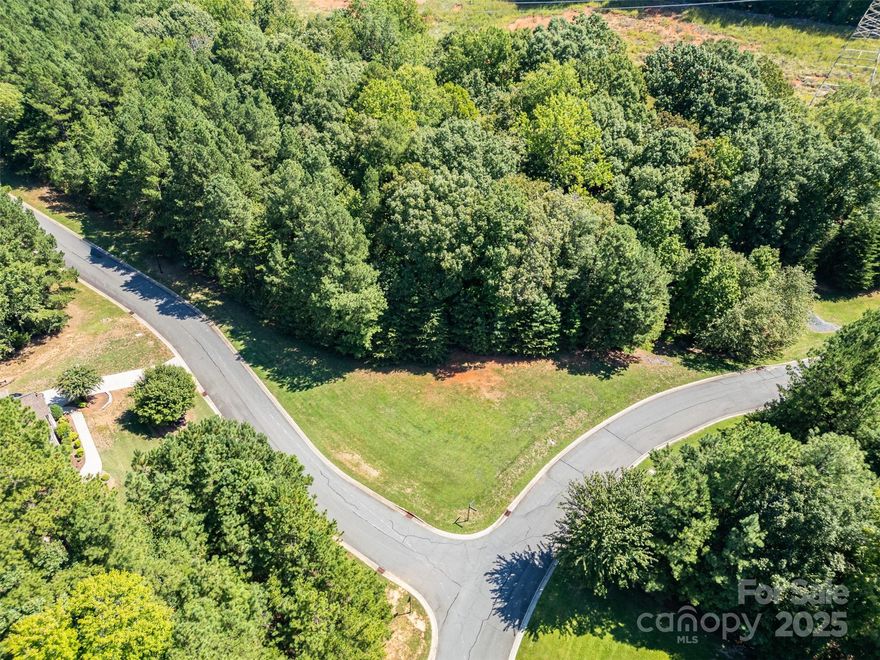 RESORT-STYLE LAKE LIVING awaits on this beautiful 1.20-acre corner lot in the prestigious, gated community of Reflection Pointe on Lake Wylie! Build your custom luxury estate in a peaceful, tree-lined setting designed for ultimate relaxation and recreation. Enjoy exceptional amenities including a clubhouse, swimming pool, ponds, soccer fields, lighted tennis courts, parks, playground, paved walking trails, and RV/boat storage. End your evenings with stunning sunsets from the community’s sandy beach and marina area. Perfectly located just minutes from charming Belmont with its restaurants, shops, college, and the Daniel Stowe Botanical Garden, plus convenient access to the new CaroMont Regional Medical Center. Create your dream lake retreat today in one of Lake Wylie’s most sought-after communities!