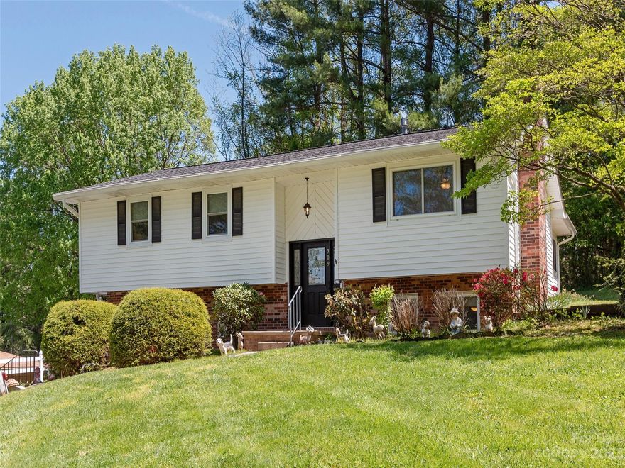 Brookland Manor gem, waiting for you to make it yours. This three bedroom 2.5 bathroom split level home, with updated kitchen, bathrooms, and flooring. Gas log F/P unvented. Three seasons sunroom, generator, newer vinyl wood flooring in the bedrooms and hallway, Newer roof & windows, tankless water heater  & A/C unit 2015. New Furnace in 2021. New dishwasher and electric range/oven 2023. The lower level offers a den with a Pool table, electric dart board, and mini fridge for entertaining. The exterior is on a gentle slope with a storage building that will convey. This home has been meticulously maintained; pressure washed the exterior in 2023 and painted the living room and entry in 2023. Close to downtown Hendersonville, stores and amenities. Must see!!