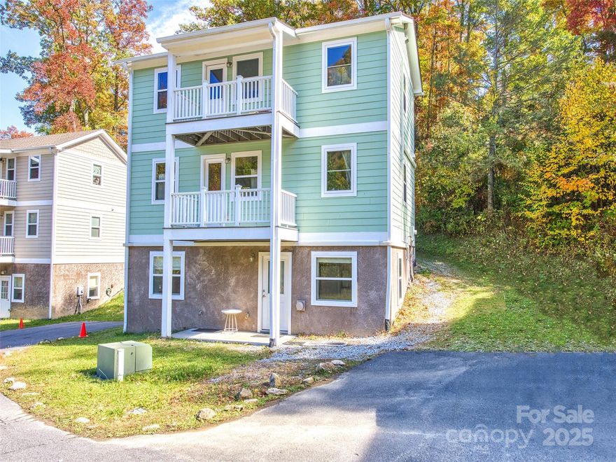 Charming 3-level cottage-style condo in the gated Mount Soma community with mountain views and flexible living spaces filled with natural light! Thoughtfully designed, the upper level features a bedroom with ensuite bath, full kitchen, dining, living area, and private deck. The main level offers a bonus room with ensuite bath, kitchenette, living/dining space, and second deck. The basement 2nd Living Quarters has a separate outside entrance with bedroom, full bath, and kitchen/living/dining area. HVAC is mini-splits with additional propane wall heaters to stay warm and cozy in winter months. Currently a successful short-term rental through Mount Soma (buyer to verify continuation). The community features peaceful outdoor spaces and walking trails. Just 30 minutes to Waynesville and 15–20 minutes to I-40 for easy access to Asheville. Ideal for a full-time home, vacation retreat, or investment opportunity in the mountains!