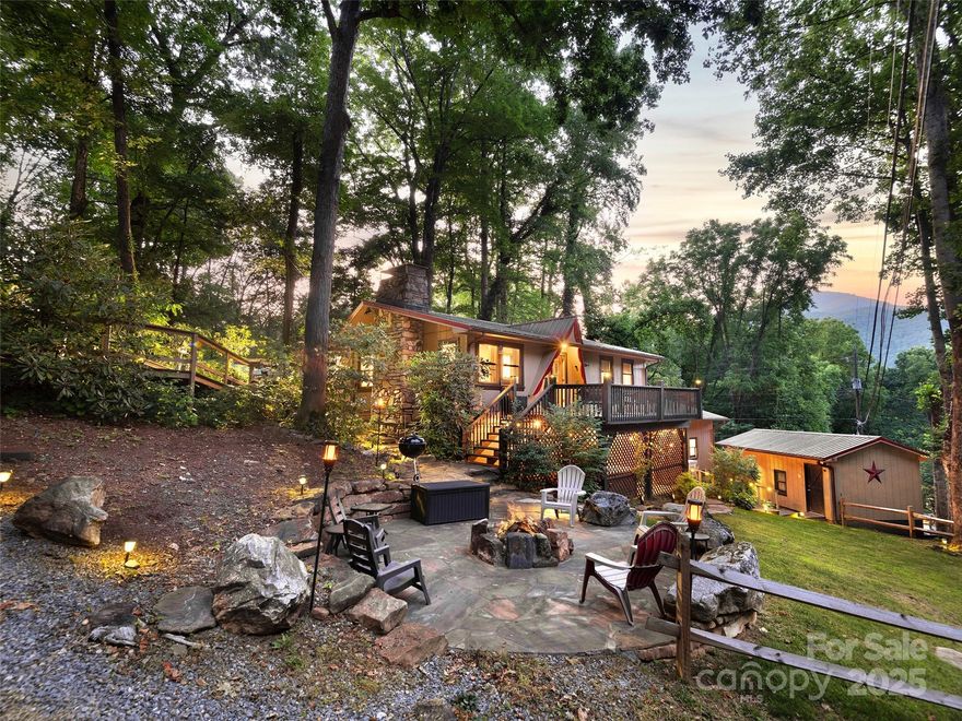 Offered fully furnished and move-in ready, this charming mountain home in the desirable Wild Acres community features year-round mountain views, a 2022 hot tub, high-speed Spectrum internet, a custom stone firepit, detached garage, and paved, easy access. The flexible layout includes two separate living quarters with a lock-off option, ideal for multigenerational living or generating rental income. Just 2 minutes from downtown Maggie Valley and approximately 10 minutes to Cataloochee Ski Area, the Blue Ridge Parkway, and Waynesville—plus only 30 minutes to Asheville and the Biltmore Estate. Currently operating as a successful vacation rental.