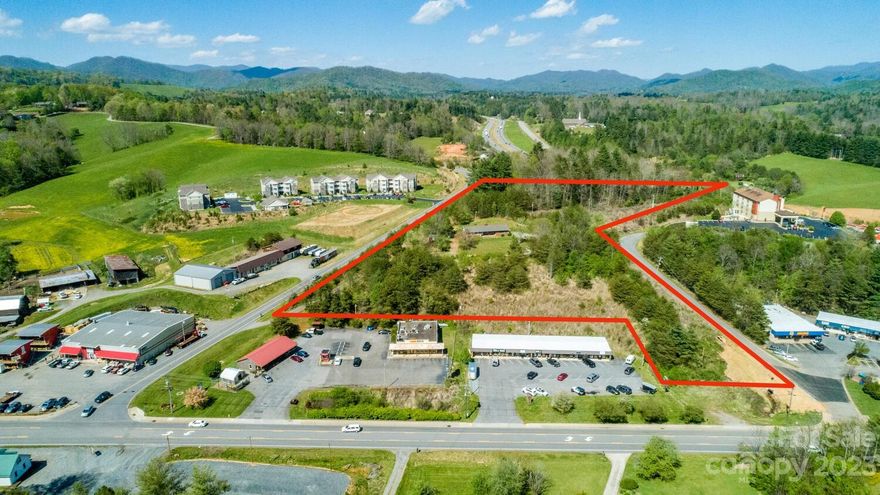 High visibility and rare prime Madison County commercial acreage zoned C2 Highway Business with many permitted uses. Quick on/off access to I-26 @ Exit 11 for easy access to Asheville, Marshall, Weaverville & E. TN.  Approx 650' frontage on Roy Edwards. Excellent opportunity to create a business right next to Builder's Express hardware store, Ingles, Madison County Welcome Center, Mars Hill University and the growing business district of downtown Mars Hill which has a thriving downtown area that includes a coffee shop, brewery, bakery & multiple resturants/galleries. Has town water and potential for sewer which the tap will need to be applied for at Town of Mars Hill. New survey as of June 2021. Red GIS line in pic is an approximation.