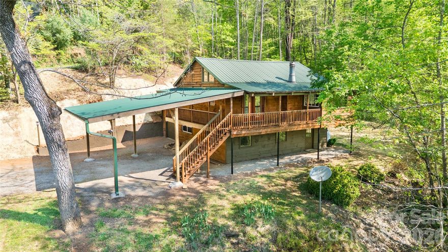 If it is a 3/2 cabin with a spacious deck and main living that overlooks the mountains with lots of privacy is what you desire, then look no further. This home is calling your name. There are so many flexible areas in this home, you almost feel like there are two homes in one. On the main level, sit in your attached sunroom and look out at the mountains through the large picture window. The pass-through garage has been sealed and repainted. It allows you to bring all your landscaping through it for easy access to a great, sunny area for your gardens thanks to the immense landscaping just completed. The lower part of the yard is screaming for a large firepit area or outbuilding. With easy access to Dillsboro, Sylva, Franklin, Cherokee, and Bryson City, and all the fun they offer, this home is perfect for those who like to explore Western North Carolina or want easy access to Western Carolina University. The young or young at heart will enjoy the Savannah Community Park with its playground, walking path, and covered picnic area along the creek. There are so many possibilities. Make this updated home thanks to the extensive improvements your own!