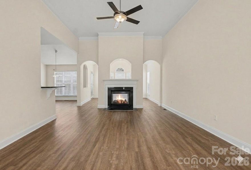 ALL NEW FLOORING BEING INSTALLED ON 3-9-26 !! This ALL-BRICK ranch is tucked away on a quiet cul-de-sac and backs to a serene wooded landscape. From the moment you step inside, the cathedral ceilings and crown molding create an airy, upscale atmosphere throughout nearly every room. The heart of the home is a spacious Great Room featuring a unique dual-sided fireplace that it shares with a bright, inviting Sunroom--the perfect spot for morning coffee regardless of the season. The gourmet kitchen boasts sleek granite countertops and a massive walk-in pantry for ultimate organization. Chose between the elegant formal dining room or the casual breakfast room for everyday meals.Versatile 4th bedroom is currently configured as a professional home office, featuring custom built-ins and classic French doors. Step through yet another set of French doors to a beautiful 30ft rear deck. The Lexan clear railings ensure your view of the beautifully landscaped yard with in-ground irrigation and private woods remain unobstructed. If there is such a thing as a 'dream garage' this house has it! Oversized at 685 square feet, this side-load garage offers a dedicated workshop area with a work bench, a sink, and an entire wall of cabinets providing more storage than you'll know what to do with. Seller has priced the home under the market value to allow for the buyer to add the flooring of their choice. You'll find this home in THE GATES AT WATERSIDE (GATES II the newer phase of the subdivision) great location basically in Denver near the intersection of Hwy 73 and Business 16.