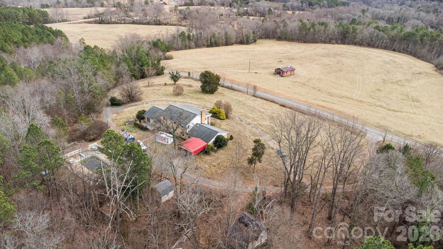 Welcome to Lawndale! This rare opportunity on 13 picturesque acres awaits your finishing touches. Please note, a portion of the property extends across the main road. This large traditional brick home features a spacious foyer or drop zone, a huge family room with tons of natural light, a formal dining room, a large kitchen with wood cabinetry, granite counter tops, mixed appliances, a breakfast area, and walk out access to the back yard. The laundry room and pantry are conveniently located right off the kitchen. A large den features built in cabinetry, a fireplace, and access to the private office area and two car garage. The main level would not be complete without a full bathroom and a guest bedroom with an amazing sized walk-in closet. Upstairs, you will find the 4 spacious bedrooms with large closets and two full bathrooms. Lastly, outside you will appreciate the circular double entry paved driveway, the two-car garage, an inground pool and pool house, and plenty of outdoor space for recreation, gardening, and hobbies. If you enjoy DIY, we got the project for you! Schedule your tour today!