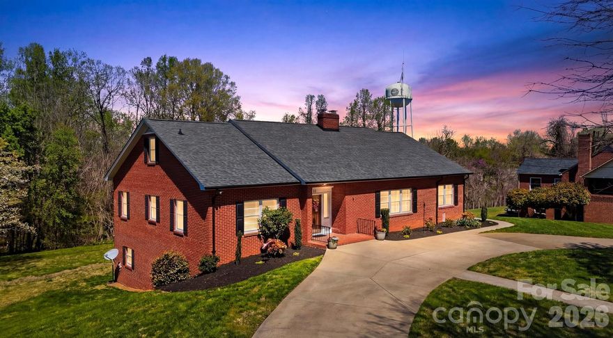 Step into a home where time seems to slow down and every corner tells a story. Nestled in the heart of charming Granite Falls, this classic brick home welcomes you with a sense of warmth that’s hard to find and even harder to leave. From the moment you arrive, the curved drive, mature landscaping, and timeless exterior hint at something truly special waiting inside. Open the door and you’re greeted by sunlit spaces, original hardwood floors, and a graceful flow that feels both expansive and inviting. The living areas are filled with natural light, anchored by a beautiful fireplace that calls for quiet mornings, meaningful conversations, and evenings that linger just a little longer. Large windows frame peaceful views, allowing the outside in and creating a calm, settled atmosphere throughout. The kitchen carries a nostalgic charm—spacious, functional, and ready for gatherings, recipes passed down, and moments that become memories. Each room offers its own personality, from cozy sitting spaces to generously sized bedrooms, all wrapped in a sense of comfort and authenticity that only a well-loved home can provide. The vintage tile bathrooms are a rare treasure—beautifully preserved, full of character, and a subtle nod to the home’s rich history. Upstairs, a sprawling attic offers endless possibilities—storage, studio, or future expansion—while the full basement and oversized garage provide incredible space for hobbies, projects, or simply room to grow. And beyond the walls, life here extends into the heart of Granite Falls—where small-town charm meets everyday convenience. Just moments from local favorites, parks, and community traditions, this isn’t just a home… it’s a lifestyle. This is the kind of place where memories are made, where traditions begin, and where someone new will fall in love with its story—just as the last owner did. Come experience it for yourself.