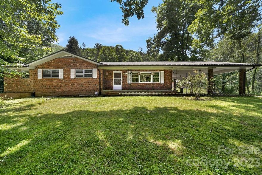 This is a rare mountain farm that has unlimited possibilities to include the 2 large barns, shop and 2 additional home sites with water, sewer, power. With beautiful mountain views and plenty of privacy. This is a great property for the horse and livestock owner. 2 space carport on main level and 1 car garage basement level. Several great garden locations. Recent up grades include a new metal roof installed in 2021, main level bath remodel and new paint in several main level rooms. This is truly a rare property 2 minute ride or walk to some of the best trout fishing still available in western North Carolina.