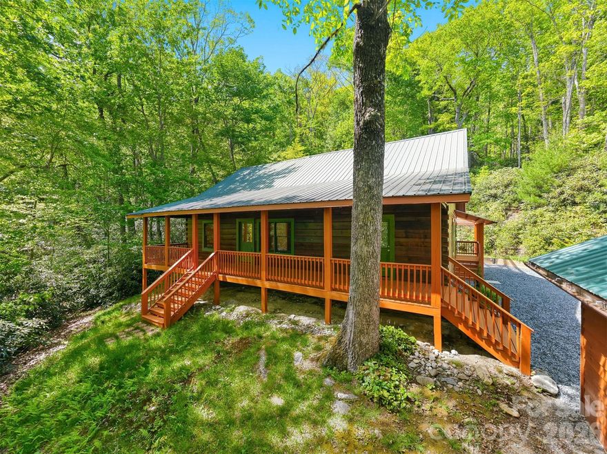 Tucked away in the gated community of Upper Creek Acres, this charming log cabin offers the perfect blend of mountain serenity and modern comfort, just minutes from the Blue Ridge Parkway and Pisgah National Forest. Set on a private wooded 0.56-acre lot, this beautifully maintained 3-bedroom, 2-bath home welcomes you with soaring vaulted ceilings in the living room and kitchen, creating an open and inviting atmosphere ideal for relaxing or entertaining.

Enjoy peaceful mountain mornings from the expansive covered front porch and unwind in the evenings on the large covered back deck surrounded by nature. The property also features a large detached garage, fully encapsulated crawlspace, french drains, and a portable generator for added peace of mind.

Recent updates include freshly painted interior walls, exterior Perma-Chink completed in 2026, HVAC system just 3 years old, and screws and washers replaced on the metal roof in Fall 2025. Kitchen appliances and washer/dryer 6 months old. Whether you’re looking for a full-time residence or a mountain getaway, this move-in-ready cabin delivers comfort, privacy, and timeless mountain charm in one of the area’s most desirable gated communities. Home is located only 14.5 miles from Grandfather Mountain and 8 miles from Linville Falls.
The home nor property were not affected by Hurricane Helene.