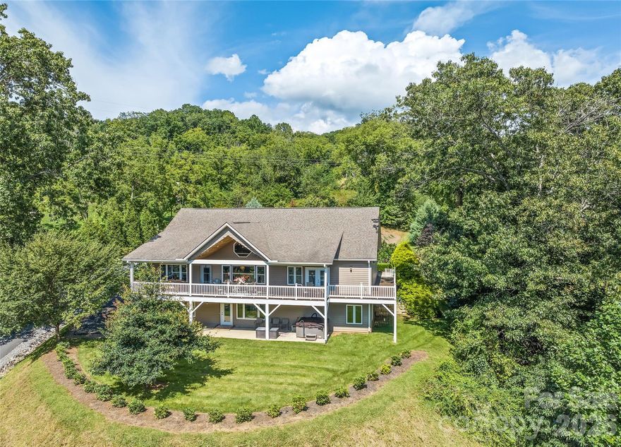 Mountain Living at Its Finest - First time on the market — and worth the wait. Tucked into the rolling hills of Waynesville, this stunning 3-bedroom, 3-bath mountain home delivers the WNC lifestyle you've been dreaming of, with year-round mountain views, thoughtful design, and room for everyone — all on a beautifully private 1.46-acre lot.
Step inside and feel instantly at home. The open floor plan flows effortlessly from the gorgeous kitchen — featuring a large island and separate breakfast bar — through the living area and up to the soaring cathedral ceiling. Single-floor living at its best, with everything you need on the main level, including a spacious primary suite with private deck access, a luxurious ensuite with roll-in shower, two vanities, and a dedicated makeup area.
Downstairs, the walkout basement takes entertaining to another level entirely. A large family room, wet bar, full bath, and generous flex room open directly to a private patio — complete with a hot tub. Whether it's a game night, a guest suite, or a short-term rental setup, this space delivers.
Outside, Trex decking wraps the home in low-maintenance beauty while you soak in those mountain views. The attached 2-car garage, ADA-compliant design throughout, and chair lift to the basement make this home as functional as it is beautiful.
All of this, just 10 minutes from town amenities, 15 minutes to the Blue Ridge Parkway and downtown Waynesville, and 30 minutes to Asheville, Cherokee, and Cullowhee. Skiing, hiking, golf, river rafting, and zip-lining are all within easy reach.