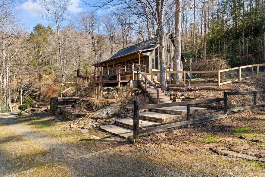 Picturesque 20-acre Equestrian Farm nestled in the foothills of western North Carolina, just 15 minutes to Blowing Rock!  Surrounded with stunning flora and fauna, privacy abounds on this gated estate lush with laurel, rhododendron, 2 streams, fenced pasture, walking trails & mature hardwoods. Four-stall barn & attached guest house. Main home has over 2,000 heated square feet with open concept living, dining & kitchen, gorgeous hardwood floors, fireplace, granite countertops, cook island. Primary suite boasts roomy walk-in closet & ensuite bath with soaking tub/separate shower. Second story has 2 oversize bedrooms & a full bath. There is a finished room w/ full bath, walk in shower in basement.  One-car, basement garage. Relax and entertain with multi-tiered decks and flagstone patio.  Barn has tack room with rough plumbing & hay loft. Attached guest house has 1 bedroom, full kitchen, full bath w/shower, loft & 1/2 bath. Fenced yard. Fenced pasture has a pole barn & creek access.