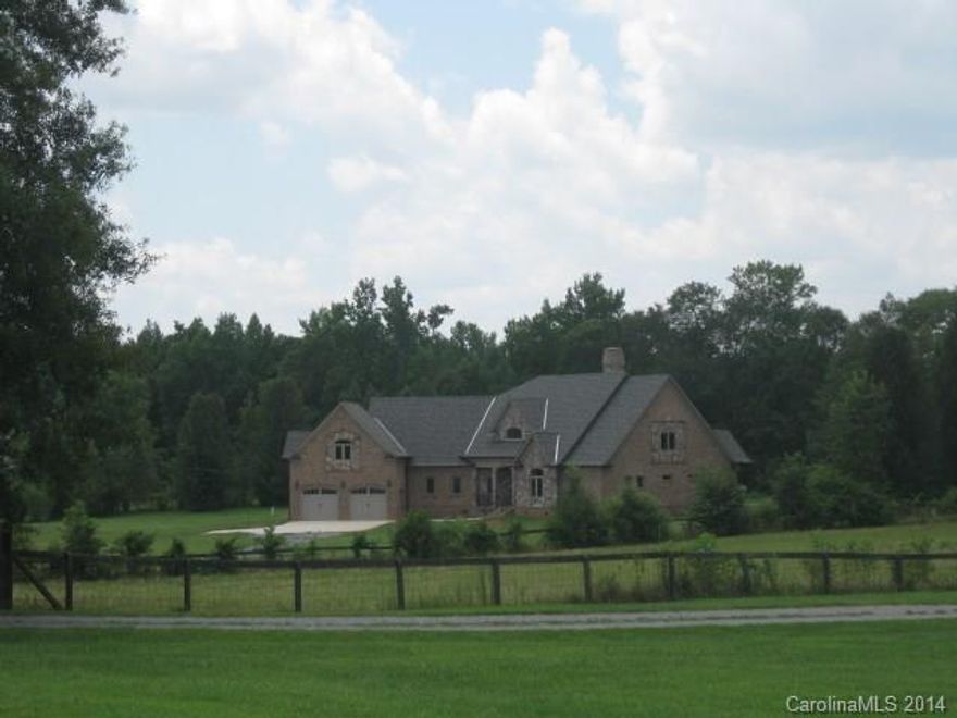 Space to spread out! Custom built home on level acreage in a private setting. Home is at stage where buyer can select granite and hardwood floor stain finish!  Built as a 4 bedroom plus office, and 2 recreation/bonus rooms.  Two story stone fireplace in the great room open to the gourmet kitchen with stainless appliances. Drama continues with a barrel vaulted formal dining room, French doors leading to the wrap around covered back porch with outside fireplace.  Additional 2car garage w/apt space