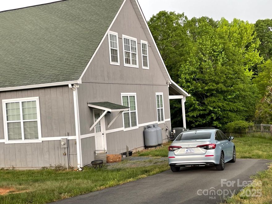 Want Rural, Farm life? GATED ENTRANCE.  This Luxury 1-bedroom open floor plan apartment with 11-foot ceilings throughout sits on a horse farm setting. KITCHEN: hardwood floors, granite countertop, stone backsplash & stainless steel appliances. BATHROOM: large bathroom with double travertine vanity, stone backsplash & porcelain tile floor. LIVING ROOM & DINING: hardwood floors and beautiful lighting.  Laundry facilities are available for tenant use. Minutes to Downtown Waxhaw.  There are two apartments in this building.  There is one upstairs and one downstairs.  This is the DOWNSTAIRS unit.  Available after 10/1. There is a $75/adult application fee. The landlord is providing ALL UTILITIES.