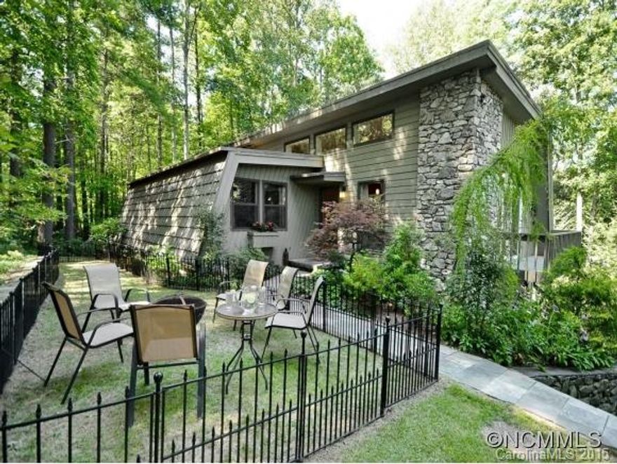 N. Asheville contemporary just minutes to downtown. Main level boasts vaulted ceiling, open floorplan, office, sunroom, huge pantry & deck to barbecue on. Lower level features spacious, open & bright in-law suite with kitchen, den, sunroom, bedroom, bath & patio. All appliances included. Work shop space in the garage. Private & wooded. What a deal!
