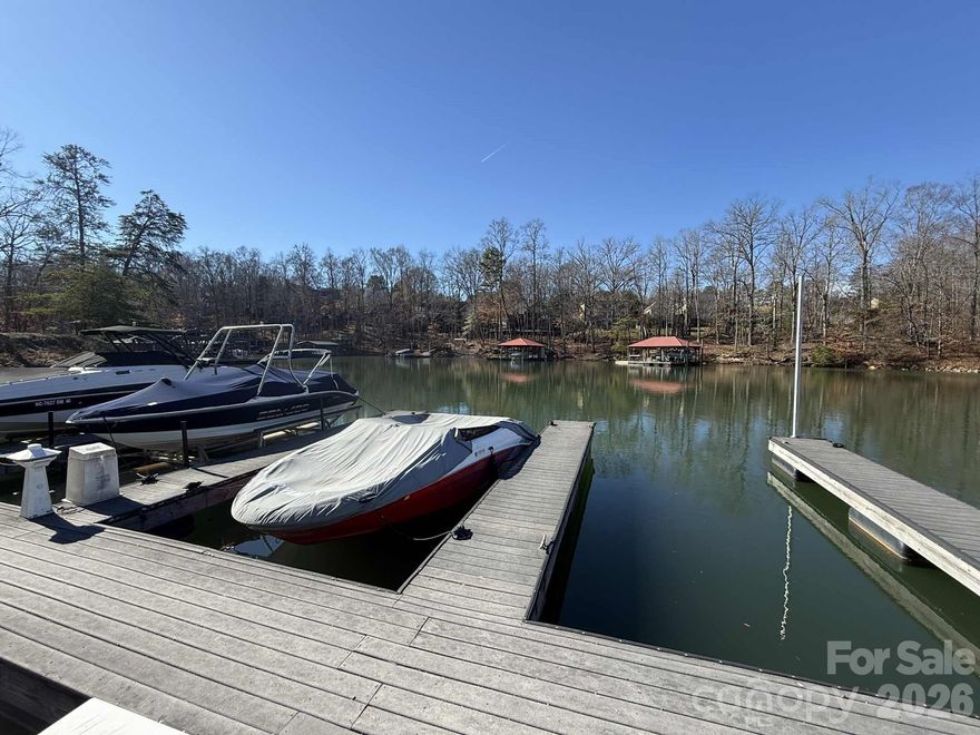 Don't miss your opportunity to access Mt Island lake with your DEEDED BOAT SLIP!! The kitchen and the primary bathroom have been updated. NEWLY PAINTED KITCHEN CABINETRY with NEW STAINLESS STEEL RANGE. This beautiful and spacious 2-story home on nearly an acre in a quiet cul-de-sac, complete with a DEEDED BOAT SLIP on Mt. Island Lake—the community’s premier feature. Offering 5 bedrooms plus a huge bonus room (optional 6th bedroom), this home includes a main-floor bedroom with a full bath and a dedicated office with French doors. Enjoy neutral paint throughout, updated LVP flooring, and an open layout connecting the kitchen, sunroom, and family room—filled with natural light and offering privacy. The newly renovated primary bath features a stunning tile shower with glass doors, dual vanities and walk-in attic access. Relax on the deck or covered front porch and appreciate nature views. Many updates have been completed, including a roof replaced 5 years ago and dual HVAC systems replaced in 2017. Located in a resort-style community with a clubhouse, neighborhood pool, pickleball courts, walking trails, multiple parks, and more. Granite countertops, abundant windows, and a versatile floor plan make this home truly move-in ready and exceptional for both daily living and entertaining.