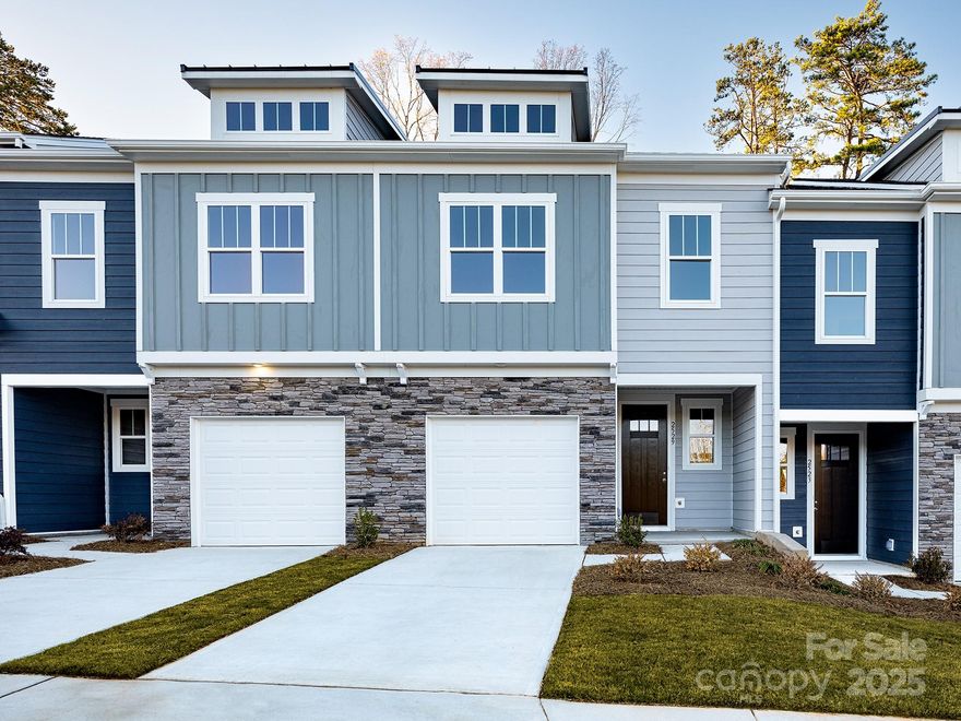 Welcome to the place where your homeownership journey begins. This beautifully crafted, low-maintenance townhome offers over 1,660 square feet of thoughtfully designed space. Nestled just 25 minutes from Charlotte Douglas International Airport and 30 minutes from Uptown Charlotte, you’ll enjoy the convenience of city access with the peace of suburban living. From the moment you step inside, the warm and welcoming foyer invites you to settle in, with a statement 8 foot door, premium flooring, a powder bath, and a coat closet that make everyday living feel effortless. The open-concept layout and spacious great room is perfect for cozy nights in or hosting friends, with dimmable lighting and access to your private outdoor patio—ideal for morning coffee or evening relaxation. It flows into a bright dining area and a stunning L-shaped kitchen, where dove-gray cabinetry, quartz countertops, stainless steel appliances, and pendant lighting create a space that’s both functional and beautiful. Upstairs, a versatile landing offers space for a reading nook, home office, or lounge area. The owner’s suite is a true retreat with dimmable lighting, a spa-like bath with quartz countertops, a walk-in shower, and a generous walk-in closet. Two additional bedrooms share a full bath, and the oversized walk-in laundry room—conveniently located near all bedrooms—adds ease to your daily routine. Built with durable Hardie board siding and soaring 9-foot ceilings on both levels, this home is designed to stand the test of time. Best of all, it qualifies for several first-time buyer programs, including zero down payment options, low down payment options with NO private mortgage insurance, and Charlotte down payment assistance grants—making your dream of homeownership more attainable than ever. Ask about our exclusive incentives available through preferred lending partners. Estimated completion is October 2025. Tour is representational.