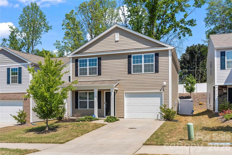 Built in 2023, this two-story home in Stewart Creek Estates is a must-see. Enter through the covered front porch into a living room featuring LVP flooring. The kitchen is well-appointed with granite countertops, stainless steel appliances, a pantry and a breakfast nook, along with direct access to the fully fenced backyard. A conveniently located half bath completes the main level. Upstairs, the primary suite offers a walk-in closet and an ensuite bath with a double vanity and walk-in shower. Two additional bedrooms, both with walk-in closets, a full bath with a tub/shower combination, and a laundry closet complete the upper level. Enjoy outdoor living on the back patio overlooking the fully fenced yard. Additional upgrades include smart home features such as switches, outlets, a thermostat, and a security system. With the home being built in 2023, you’ll have peace of mind knowing the roof, HVAC, and water heater are all just a few years old. Conveniently located with access to I-85, I-77, Uptown Charlotte, Charlotte Douglas International Airport, as well as shopping and dining, this home truly has it all.