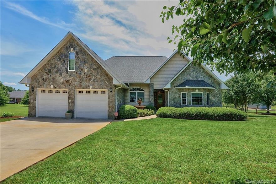 Wonderfully upgraded throughout this custom built home! Real hardwoods in the main living area. Family room with stone fireplace, wine cabinet and cooler, recessed lighting and 10 foot ceiling. Wonderful kitchen with island, pantry,stainless steel appliances and granite tops. Large master suite with tray ceiling. 2 bedrooms share a jack and jill bath and have walk-in closets.  laundry room with sink and cabinets. Deck with canopy and outbuilding. Security system with cameras.