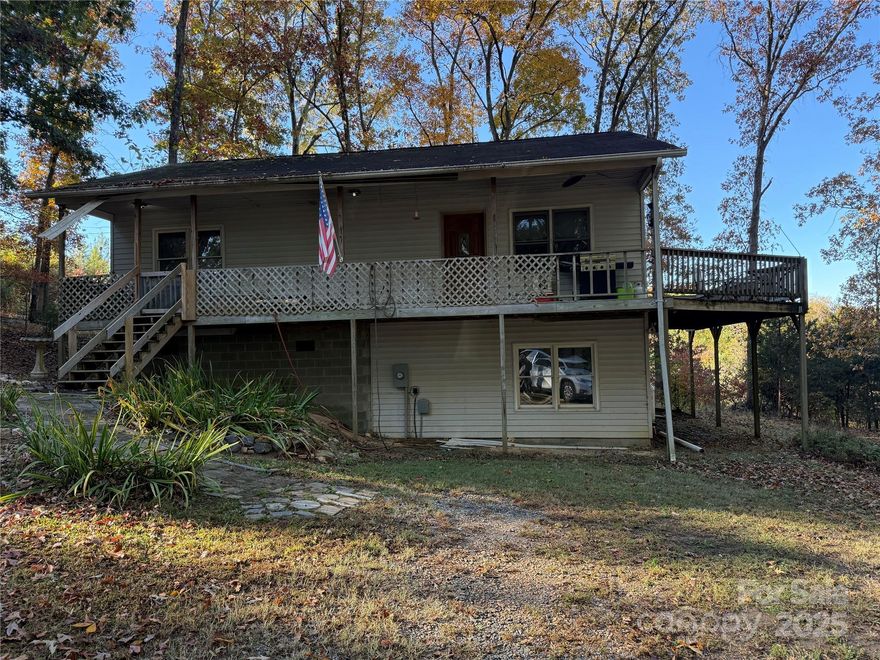 Investor special in a peaceful country setting! Tucked back off the road and surrounded by nature, this spacious lot offers privacy and quiet, yet you're just minutes from all the shops, dining, and conveniences of Indian Land and Waxhaw. The existing 2-bed, 1-bath home includes a secondary family room, kitchenette and additional unfinished bath in the basement, offering potential for renovation or rental while you plan your dream build. Wrap-around deck, mature trees, and tons of room to create your vision. Enjoy privacy with the home set back off the county maintained road. This property offers much potential- bring your plans and make it your own.