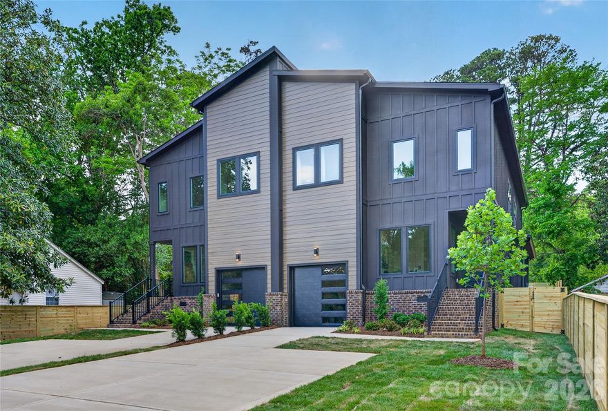 Make the smart play.. and enjoy the luxury of living steps from the course! This elevated Duet Home offers the space, feel, and functionality of a single-family home, at a fraction of the price.  Set on one of the community’s premier streets with golf course views and seasonal glimpses of Uptown and Southend. Designed for both everyday comfort and effortless entertaining, this home truly lives larger than expected. Inside, a bright and open floor plan welcomes you with abundant natural light and seamless flow. With 5 bedrooms and 3 bathrooms, there’s room for guests, work-from-home flexibility, or multi-generational living. The modern kitchen anchors the space with sleek waterfall countertops, ample cabinetry, and generous storage. What sets this home apart are the thoughtful upgrades and outdoor enhancements. Built on a crawlspace foundation, it also features a beautifully finished stamped concrete patio, creating an ideal extension of your living space. The fully sodded, move-in-ready backyard offers immediate usability.. no waiting, no extra investment. Additional highlights include a fully equipped wet bar, custom built-in pet station, and spray foam attic for improved efficiency. Located in the rapidly growing Revolution Park area, you’re just minutes from South End, Uptown, and the airport, with close proximity to parks, greenways, dining, shopping, a community driving range, and the golf course right nearby. NO HOA and exceptional value for the size, location, and lifestyle.  This is a rare opportunity to own a home that truly delivers more for less.