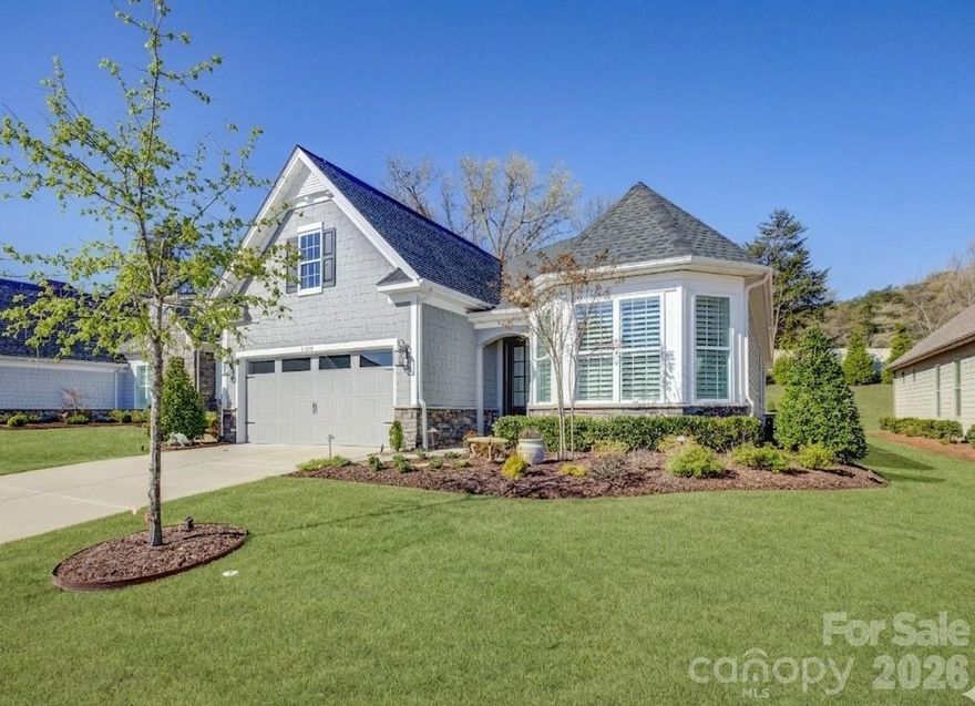 Located in the amenity-rich Regency at Palisades neighborhood, this meticulously maintained home is filled with thoughtful upgrades and custom details that make it a true standout. A striking custom steel front door welcomes you into an interior adorned with rich wood flooring, custom plantation shutters, and designer drapery panels throughout. Just off the entry, a private study or formal living room offers a quiet retreat. The open-concept layout seamlessly connects the gourmet kitchen, dining area, and living room, creating an ideal space for everyday living and entertaining. The stunning kitchen features crisp white cabinetry, a large prep island with a single-bay sink, a gas cooktop, a wall oven, an eye-catching tile backsplash, and beautifully customized pantry and butler’s pantry cabinetry. Sliding glass doors with a remote-controlled blind lead to a screened porch with cool travertine flooring, perfect for year-round enjoyment, overlooking a stone patio and a backyard enhanced with tasteful garden lighting and French drains. The oversized primary suite is a serene escape with a tray ceiling, dual vanities, a glass-enclosed tiled shower, and an impressive custom closet. A well-appointed laundry room with a utility sink, folding counter, and additional custom cabinetry makes daily tasks a pleasure, while two spacious secondary bedrooms share a hall bath. This exceptional home blends comfort, function, and elegance in every detail.