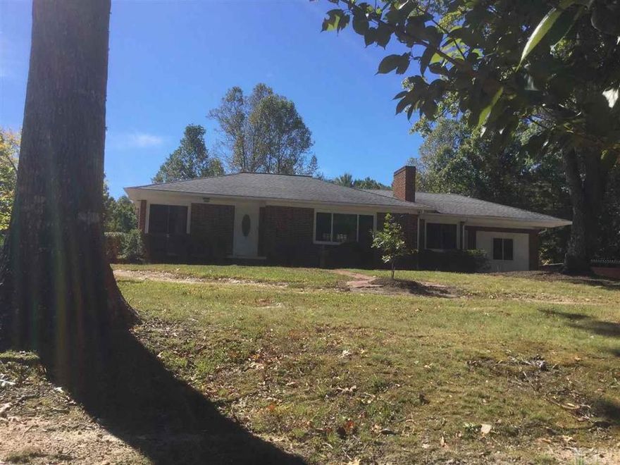 A country charmer, abeautiful country brick home with hip roof, very nice rock fireplace, circle drive, and 4 car detached garage with huge storage warehouse, you will not have a storage problem with this home, all centered around a beautiful setting. This house has been remodeled completely by a licensed contractor and Public Utilities contractor. New stainless appliances, new doors, new baths, new recepticles, new lights new floors, and new metal roofs on the garage buildings. These garage buildings could be easily rented. The home has all new tilt out windows and is very well built. A nice concrete covered back porch gives you a great place to relax and enjoy the outside.The hardwood floors have been refinished so that you can see the old hardwood floors and what a nice look they provide. Sometimes a house fits where it is built, and this one does. Take some time to look at this one because it affords a lot of options.