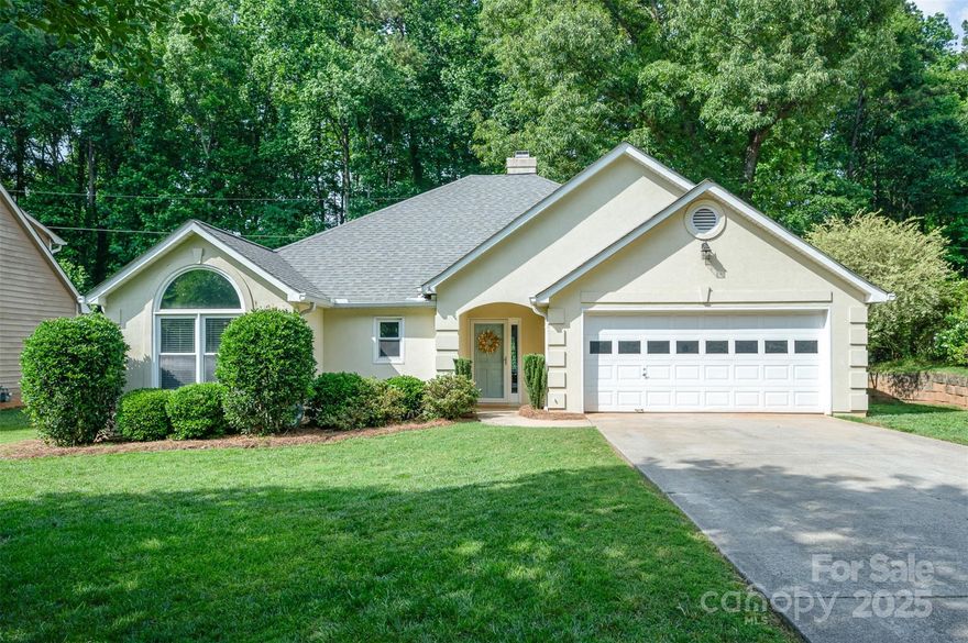 Welcome to this beautifully updated 3 bedroom, 2 bath ranch-style home tucked away in a peaceful, wooded setting in highly sought-after Fort Mill. Enjoy the freedom of no HOA while relaxing in your private backyard that backs up to serene woods—offering a tranquil space. Inside, you'll love the open feel with inviting living room centered around a cozy fireplace with custom built-ins. The updated kitchen features white cabinets, granite countertops, new lighting, and stainless steel appliances. New flooring flows throughout the main spaces, enhancing the spacious living areas.  Retreat to the primary suite, which features an updated bath complete with freshly painted cabinets, new lighting, and a beautifully tiled walk-in shower with a sleek new enclosure. Step into the stunning all-seasons sunroom, flooded with natural light and perfect for relaxing year-round. With thoughtful updates throughout and a prime location with top-rated schools, shopping, and dining—this home offers it all!