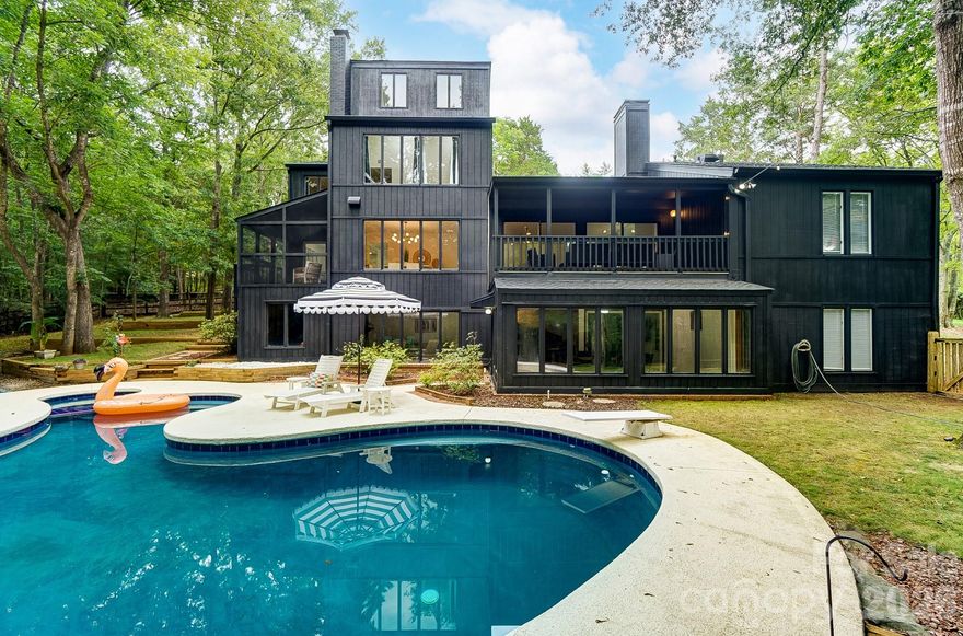 Rare opportunity to secure an exceptional homesite in a truly dream-worthy setting: a remarkably large lot in exclusive Five Knolls Estates, with no HOA. Enjoy privacy, mature landscaping, and a quiet presence that’s increasingly hard to find – yet with easy access to dining, shopping, and everyday conveniences.

All of the timeless appeal of mid-century design: clean lines, large gathering spaces, and walls of windows that create a strong indoor-outdoor connection. Lush greenery provides a gorgeous backdrop most of the year, with absolutely stunning foliage each fall.

The primary suite is an oasis on the entire third floor with phenomenal natural light and thoughtful details like a giant, cedar-lined closet.
The kitchen and bathrooms are ready for updating, presenting a compelling opportunity to tailor the home to your own taste—whether that means honoring the original aesthetic or a reimagined vision. This property invites you to create a personalized residence that is as distinctive as the neighborhood itself.

If you love to entertain, the newly resurfaced pool and hot tub will be the epicenter of every party, with an inviting rec room and brick-floored sunroom to welcome guests inside after a swim. 
If you love to garden, the terraced side yard is just waiting for your inspiration.
If you love to golf, then you probably already know that this location is truly a golfer’s haven – just a stone’s throw from Carmel Country Club’s South Course, one of their 2 championship golf courses. It’s also nearby to 2 more courses, Cedarwood (5 mins away) and Quail Hollow (12 mins). 

More than a home, welcome to a long-term investment in lifestyle, location, and legacy.

Photos 44-48 are AI generated for illustrative purposes only to show potential renovations ideas.