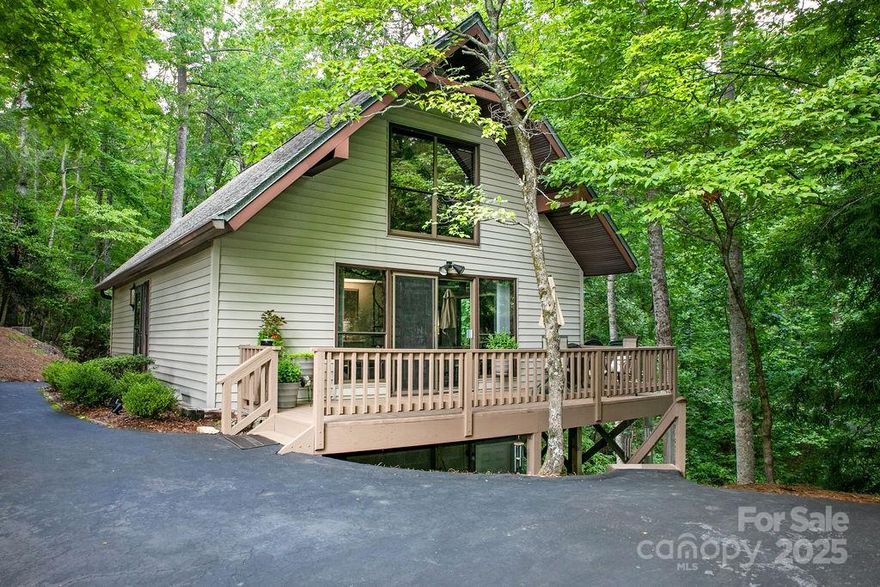 Here it is! A smaller, less expensive home in the beautiful community of Connestee Falls. This cozy home has loads of charm and has been meticulously maintained. The open, main-level great room is surrounded by glass doors that bring natural light & the wooded surroundings inside. Two open decks off of the great room expand the living area and offer outside options for living & entertaining. Two-story ceilings with exposed beams add a lofty & expansive feel to the comfortable space. Two roomy bedrooms & two full baths flank the living area, each with sliders that open to a third deck. Up the spiral staircase, the spacious loft enjoys an expansive wooded view out of the floor-to-ceiling window. Currently used as a media & office space, this room has so many possibilities...  Arts & crafts?  Rec room & lounge area?  Although this home is perfectly comfortable as it is, with a few creative updates, it could be a showstopper! New Connestee residents pay a $13,500k amenity fee at closing.