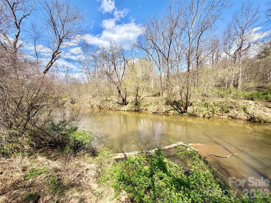 Nestled on just under 8 acres of peaceful countryside, this unique 3 br 2 ba property offers the perfect blend of privacy, space, and versatility.  A pictuesque stream runs along the back of the property, creating a serene natural setting ideal for relaxing or exploring. The property features an ensuite bathroom that includes a separate toilet and shower room and also his and hers closets. Outside, you will find a detached garage/workshop--perfect for hobbies, storage, or projects--as well as a large barn that adds endless possibilities and could be used for equipment, animals, or additional workspace. If you're looking for quiet country living with multiple uses, this private retreat is a rare find.