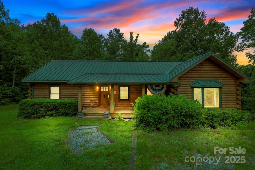 **Seller says "let's get it done"....price reduced**  This classic cabin on over 2 acres of wooded privacy offers the perfect blend of rustic charm and modern comfort. Step inside and find open living areas with vaulted ceilings, tongue and groove finishes, and a welcoming cabin feel throughout. The spacious kitchen features high-quality cabinetry and beautiful granite countertops, ideal for entertaining. Enjoy the ease of one-level living with all bedrooms and key elements on the main floor.  A generously sized primary suite with a walk in closet and en-suite bath is tucked on one side of the floor plan, with two guest bedrooms, and another full bath on the other. The finished basement adds flexible space for guests, a game room, or family gatherings. A jumbo 2-car garage provides ample room for vehicles and storage. The cozy covered front porch and enormous rear deck offer great spaces for some R&R.  Situated in a peaceful, tranquil setting with easy access to downtown Saluda, this home is a serene retreat you’ll never want to leave.  Extra acreage possible if desired!