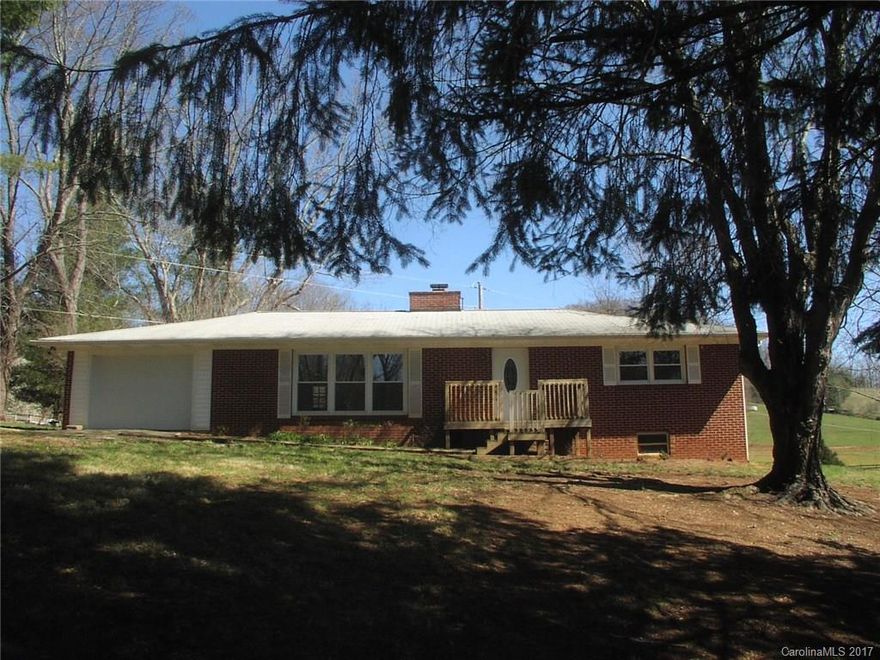 Great one level Brick Ranch in Ratcliff Cove area and Junaluska School District, new stainless refrigerator, new range, Corian counter tops, refinished hardwood floors, new bath, tile, new paint, new septic field, 2 big bdrm 1.5 ba, enclosed sunroom(not counted in HSF), main level garage, basement with plenty of workshop space,nice level lot and great location just outside Waynesville City limits,(no city taxes), close to hospital, schools, shopping.Seller related to agent