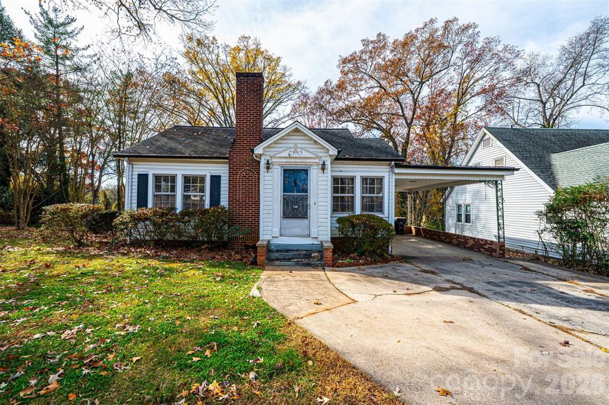 A little imagination is all that's needed for this cute bungalow in the heart of Statesville! You can't afford NOT to consider this one! Vinyl siding/trim Bungalow; 3BR/1.5BA; huge LR off of foyer has space for everyone; BR1 right off LR has real wood panelling & trim; half BA has stackable washer/dryer (conveys); den/formal DR has pass thru window into kitchen, built-in cabinets/shelves, plus a large closet; kitchen was remodeled in 2024 w/LVP flooring, removed cooktop/wall oven & added laundry hook ups & new elec range, kit also has a DW, ref, & built-in pantry cabinets; breakfast nook in kitchen has cute built-in dining booth & door to side porch; 2 other large BRs plus a full BA & a cedar lined closet round out the main level! Partial unfinished basement has concrete flrs. 200 amp circuit breaker service. 2024 elec water heater. 2016 gas pack/CA. 3-4 years ago power lines were moved underground.  Sold As Is.